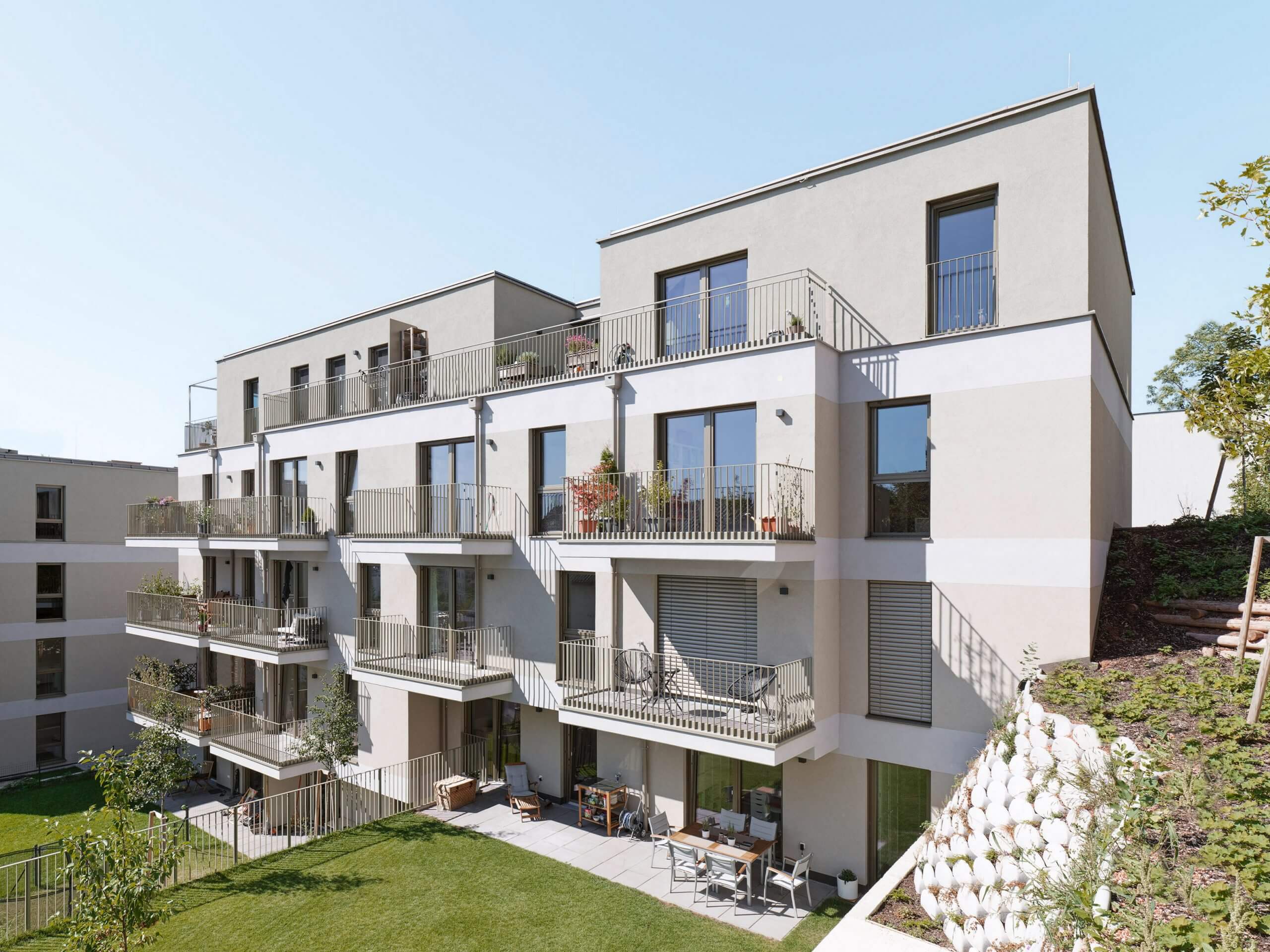 Modern apartments with balconies and greenery
